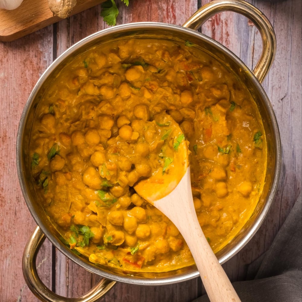 Finished chickpea curry with cashew cream in a pot.