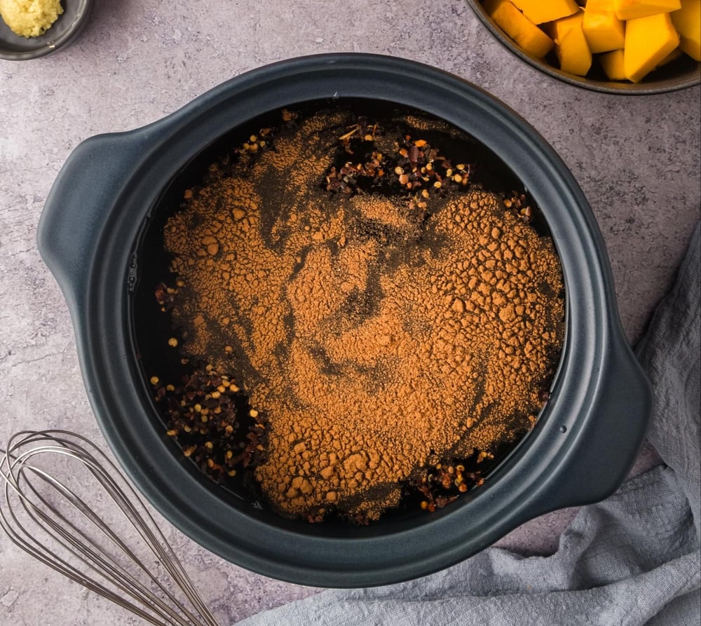Vegetable broth and seasonings mixed in a pot.