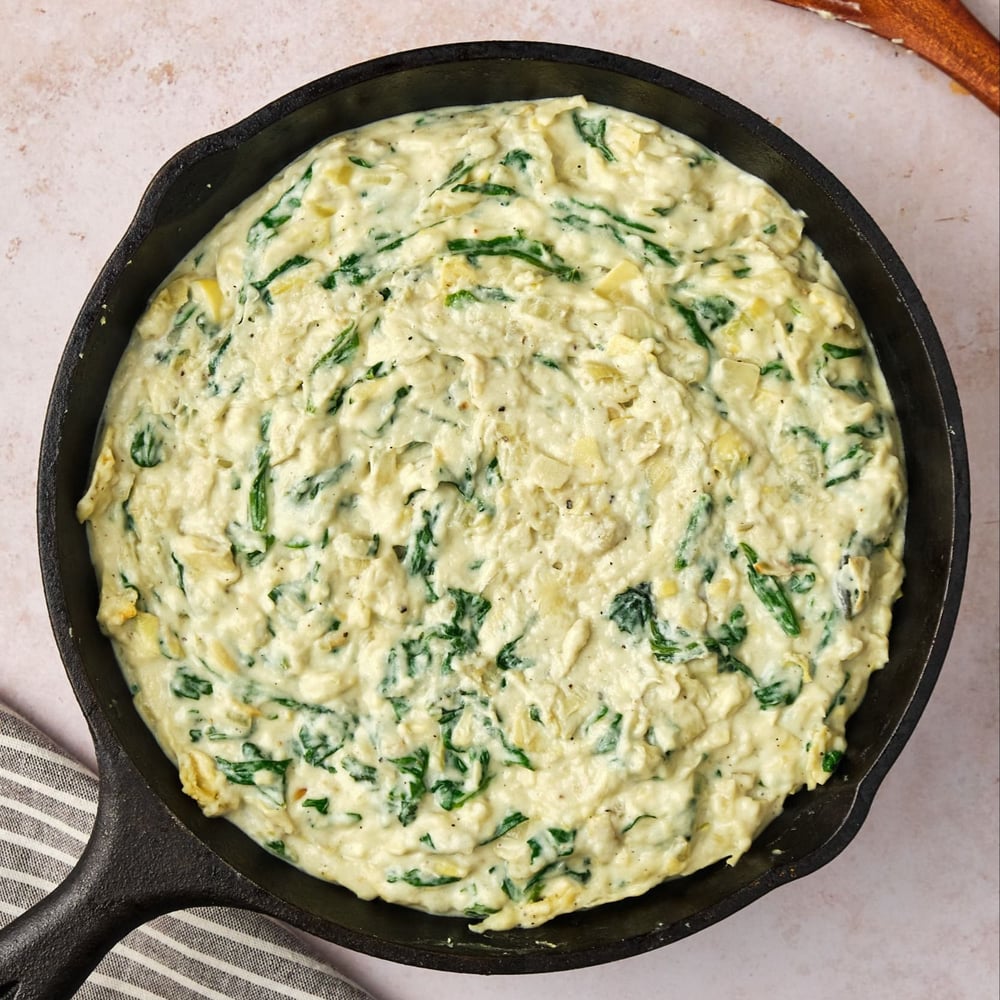 Vegan spinach dip in a pan, before broiling.