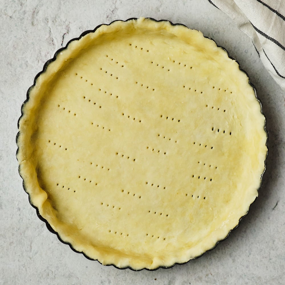 Vegan shortcrust dough in a tart pan.