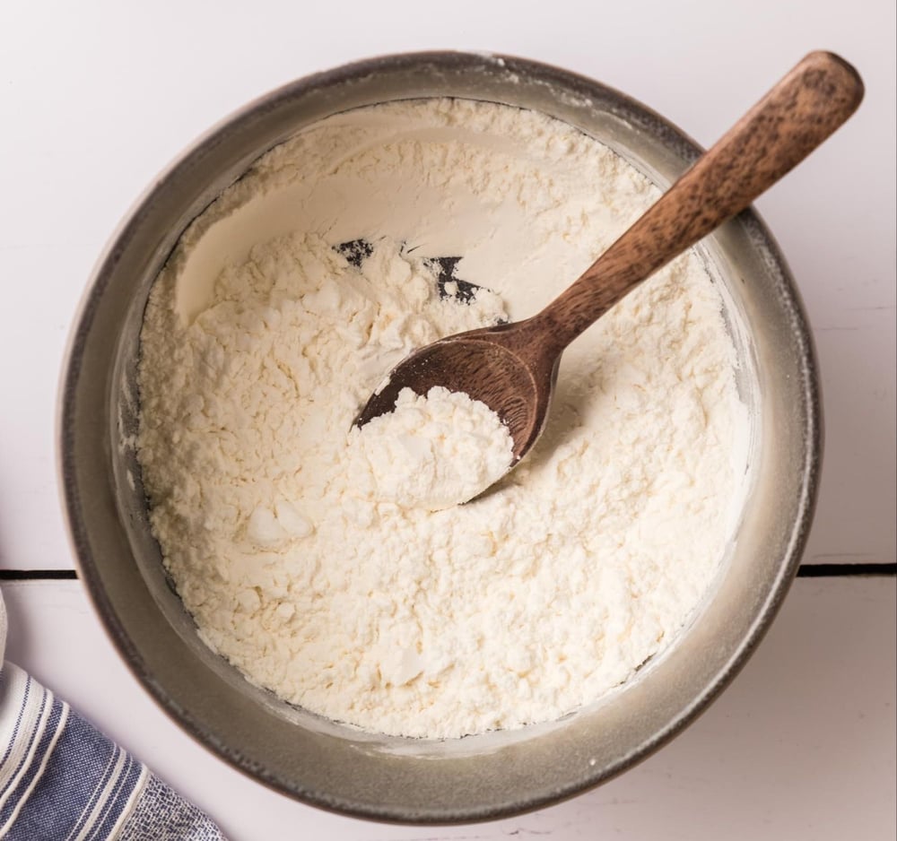 Coating mix, mixed together in a bowl with a spoon.