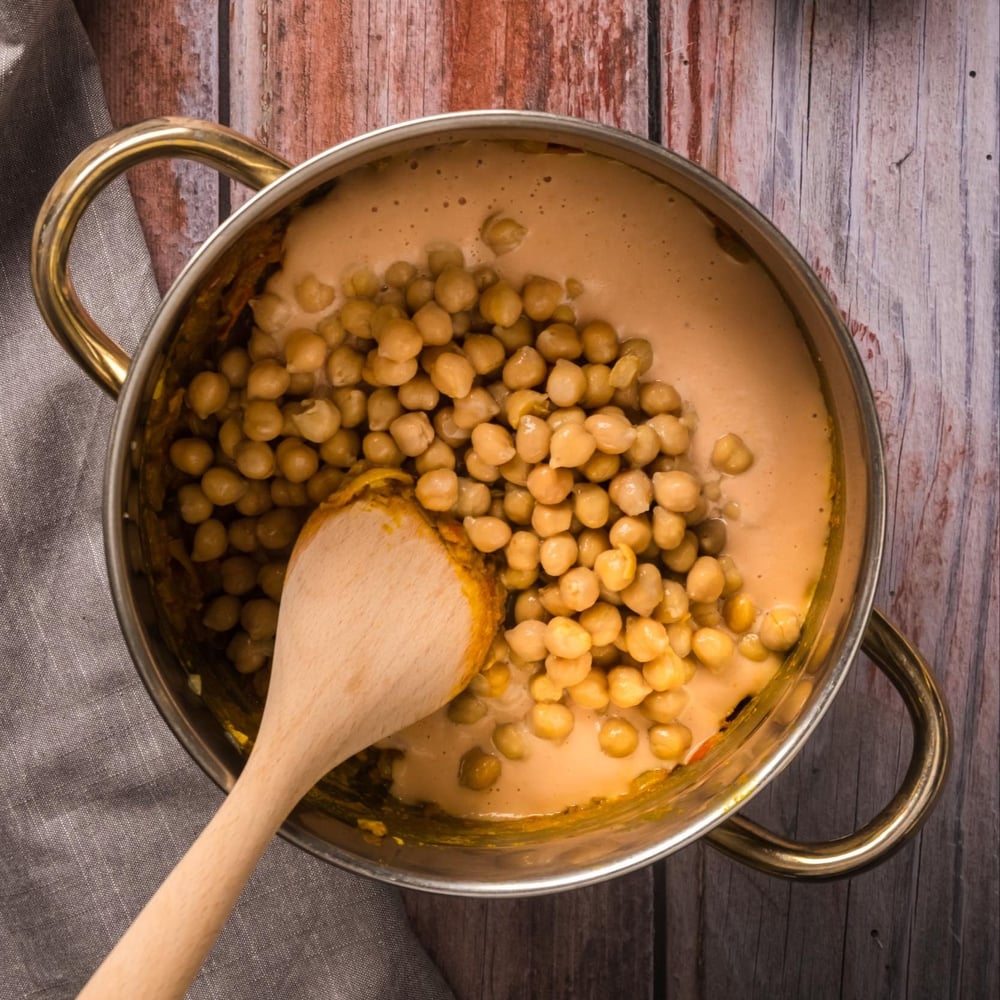 Cashew tomato sauce and chickpeas added to the pot.