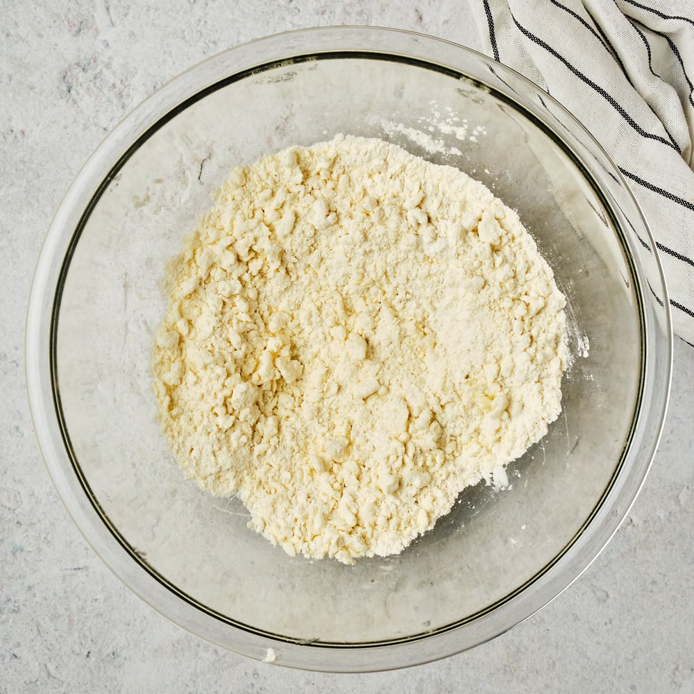 Vegan shortcrust dough in a mixing bowl, before adding water.